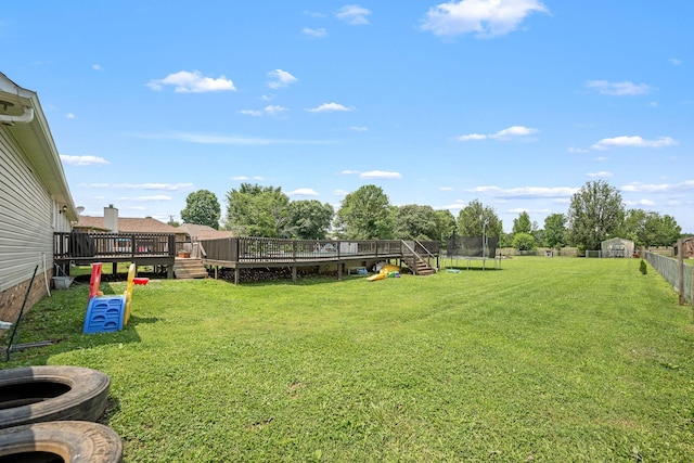 229 Wellington Way, Smyrna, TN 37167 - view of yard featuring a trampoline, a deck, a storage unit, and a fire pit