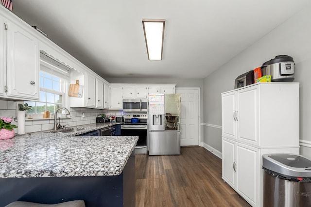 229 Wellington Way, Smyrna, TN 37167 - kitchen with appliances with stainless steel finishes, white cabinetry, and dark wood-type flooring