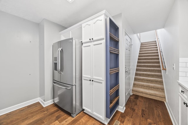 2135 Loudenslager Dr, Thompsons Station, TN 37179 - kitchen featuring stainless steel fridge with ice dispenser, white cabinetry, dark wood-style flooring, and light countertops