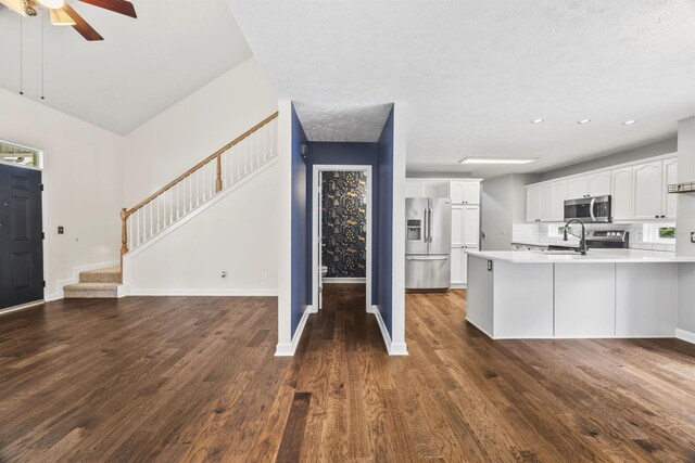 2135 Loudenslager Dr, Thompsons Station, TN 37179 - kitchen with stainless steel appliances, a peninsula, white cabinets, light countertops, and ceiling fan
