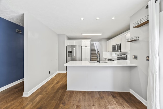 2135 Loudenslager Dr, Thompsons Station, TN 37179 - kitchen with stainless steel appliances, recessed lighting, a peninsula, white cabinets, and tasteful backsplash