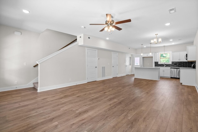 109 Adkins St Unit A, Clarksville, TN 37042 - unfurnished living room with ceiling fan, light wood-type flooring, stairway, recessed lighting, and a chandelier