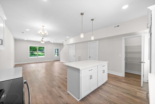 109 Adkins St Unit A, Clarksville, TN 37042 - kitchen featuring a chandelier, light wood-type flooring, range, white cabinets, and pendant lighting