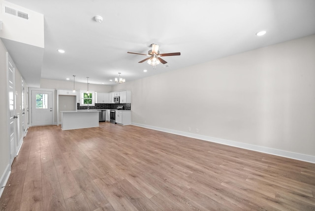 109 Adkins St Unit A, Clarksville, TN 37042 - unfurnished living room with light wood-style floors, a ceiling fan, recessed lighting, and a chandelier
