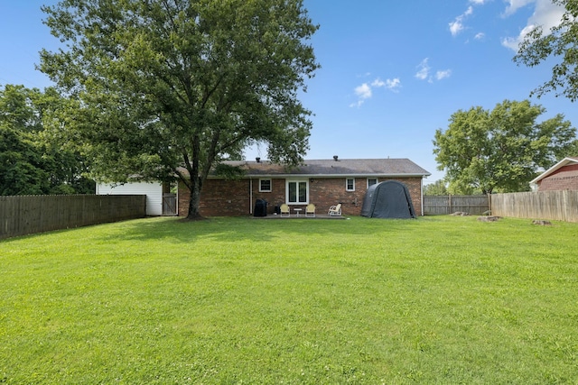 1651 Caughran Rd, Lewisburg, TN 37091 - back of property with a fenced backyard, brick siding, and a patio