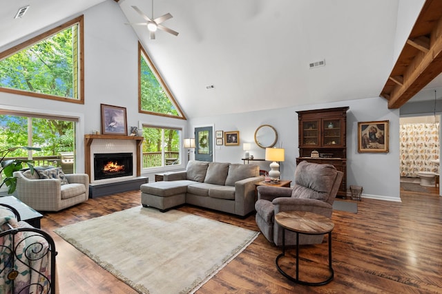 2113 Culleoka Hwy, Culleoka, TN 38451 - living area with high vaulted ceiling, a warm lit fireplace, a ceiling fan, and dark wood-style floors