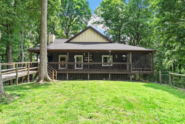 2113 Culleoka Hwy, Culleoka, TN 38451 - back of property with a chimney, board and batten siding, a fenced backyard, a sunroom, and a shingled roof