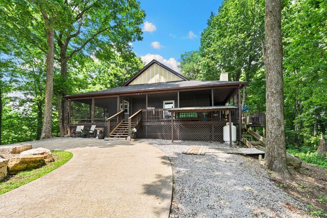 2113 Culleoka Hwy, Culleoka, TN 38451 - view of front of property with board and batten siding, a chimney, a sunroom, driveway, and covered porch