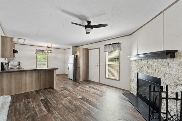 2113 Culleoka Hwy, Culleoka, TN 38451 - kitchen with freestanding refrigerator, ceiling fan, dark wood-style floors, a peninsula, and a textured ceiling