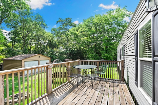 2113 Culleoka Hwy, Culleoka, TN 38451 - deck with outdoor dining area, a garage, a lawn, view of scattered trees, and a shed
