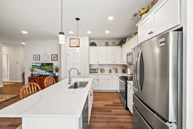 1425 Village Loop, Cookeville, TN 38501 - kitchen featuring appliances with stainless steel finishes, recessed lighting, wood finished floors, a kitchen island with sink, and white cabinetry