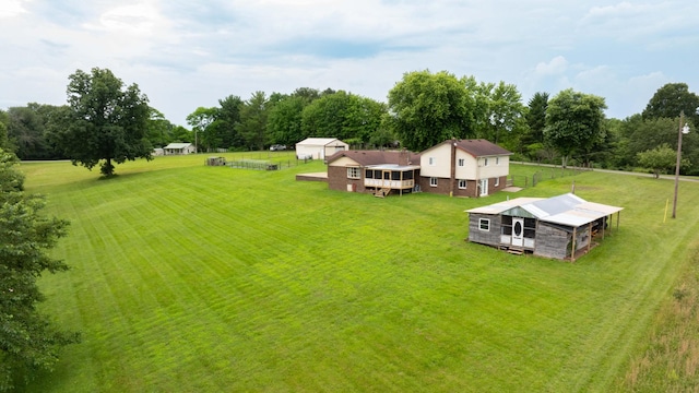 3037 Tunnel Rd, Westmoreland, TN 37186 - view of grassy yard with an outdoor structure, exterior structure, a wooden deck, and view of wooded area