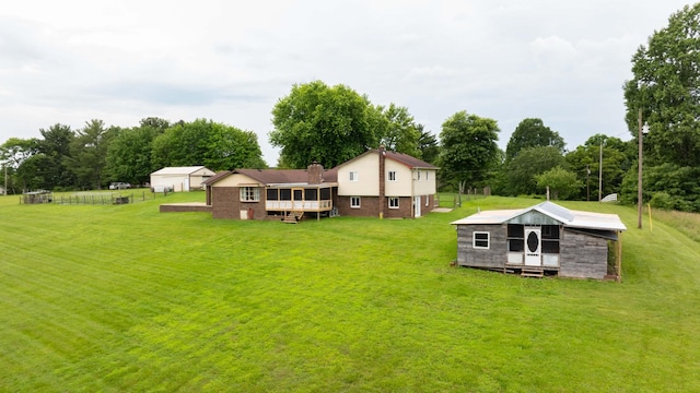3037 Tunnel Rd, Westmoreland, TN 37186 - rear view of property featuring a yard, an outdoor structure, a deck, and view of scattered trees