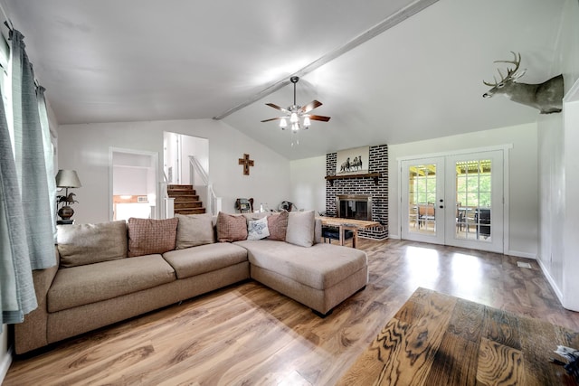 3037 Tunnel Rd, Westmoreland, TN 37186 - living room featuring wood finished floors, ceiling fan, french doors, a brick fireplace, and stairway
