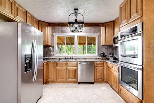 3037 Tunnel Rd, Westmoreland, TN 37186 - kitchen with stainless steel appliances, backsplash, and dark stone countertops