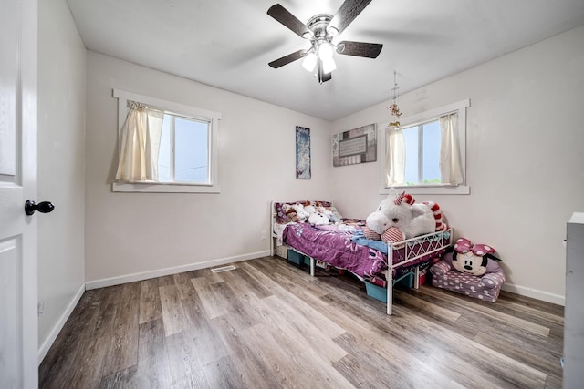 3037 Tunnel Rd, Westmoreland, TN 37186 - bedroom featuring multiple windows, wood finished floors, and ceiling fan