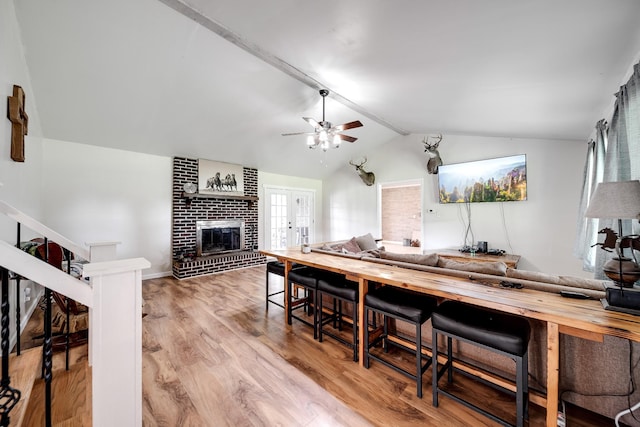 3037 Tunnel Rd, Westmoreland, TN 37186 - kitchen with lofted ceiling, a brick fireplace, ceiling fan, wood finished floors, and open floor plan