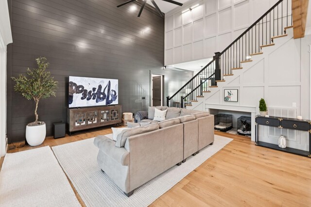 1485 Harrison Rd, Murfreesboro, TN 37128 - living area with ceiling fan, stairs, light wood finished floors, a decorative wall, and a towering ceiling