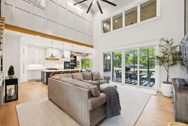 1485 Harrison Rd, Murfreesboro, TN 37128 - living room featuring a high ceiling, light wood-style floors, and ceiling fan