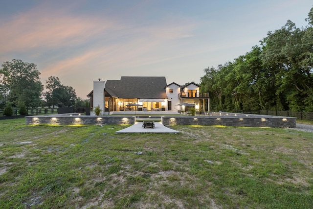 1485 Harrison Rd, Murfreesboro, TN 37128 - back of property with an outdoor fire pit, a patio, and a chimney