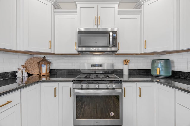 134 Chisum Ct, Clarksville, TN 37043 - kitchen with appliances with stainless steel finishes, tasteful backsplash, white cabinets, and dark stone countertops