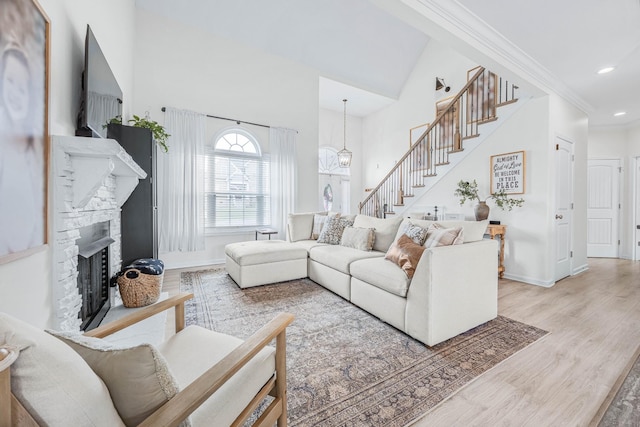 134 Chisum Ct, Clarksville, TN 37043 - living area with stairway, wood finished floors, a stone fireplace, a towering ceiling, and recessed lighting