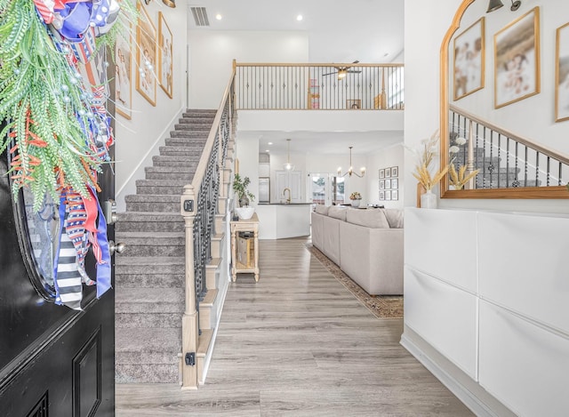 134 Chisum Ct, Clarksville, TN 37043 - entrance foyer with stairs, a towering ceiling, wood finished floors, recessed lighting, and a chandelier