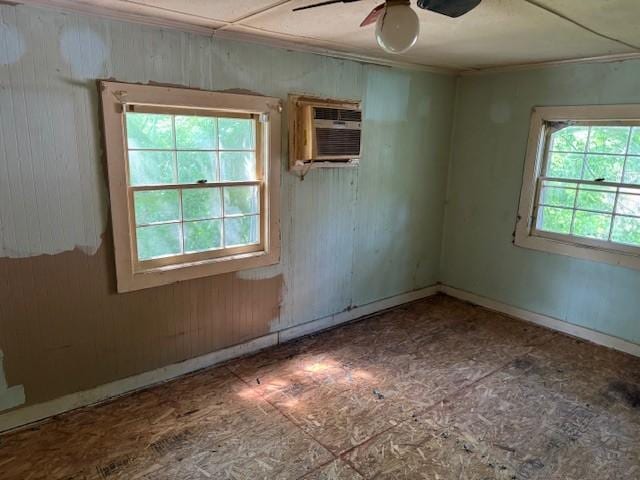 421 Hickman St, Columbia, TN 38401 - unfurnished room featuring a wall unit AC, crown molding, ceiling fan, and wood walls