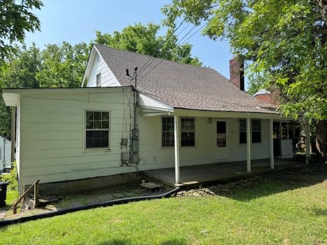 421 Hickman St, Columbia, TN 38401 - back of property featuring a chimney, a lawn, a patio area, and roof with shingles