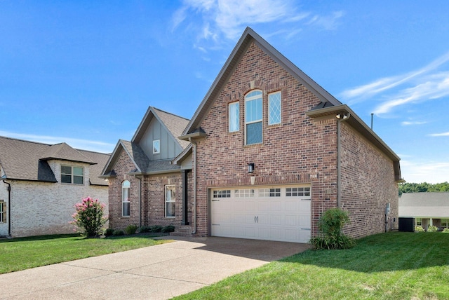215 Ernest Dr, Lebanon, TN 37087 - view of front of house with a garage, driveway, a front lawn, and brick siding
