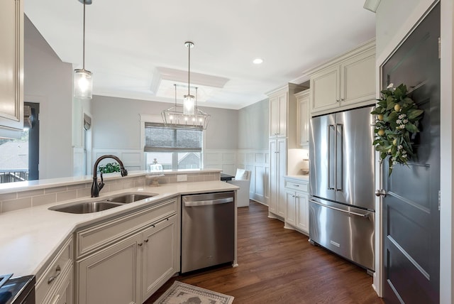 215 Ernest Dr, Lebanon, TN 37087 - kitchen featuring stainless steel appliances, light countertops, dark wood finished floors, a decorative wall, and decorative light fixtures