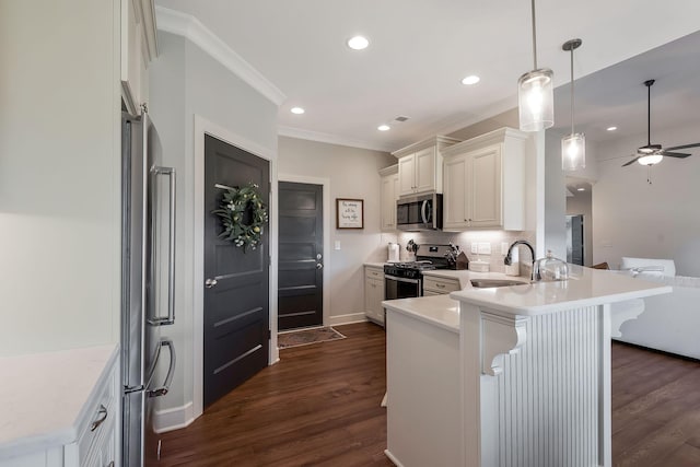 215 Ernest Dr, Lebanon, TN 37087 - kitchen featuring stainless steel appliances, a peninsula, ceiling fan, a breakfast bar, and light countertops