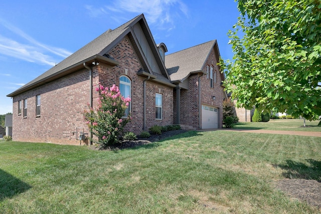 215 Ernest Dr, Lebanon, TN 37087 - view of side of home with brick siding, concrete driveway, a yard, and an attached garage