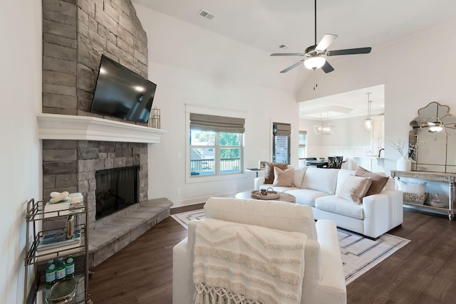 215 Ernest Dr, Lebanon, TN 37087 - living room with dark wood-style flooring, a ceiling fan, a stone fireplace, and high vaulted ceiling