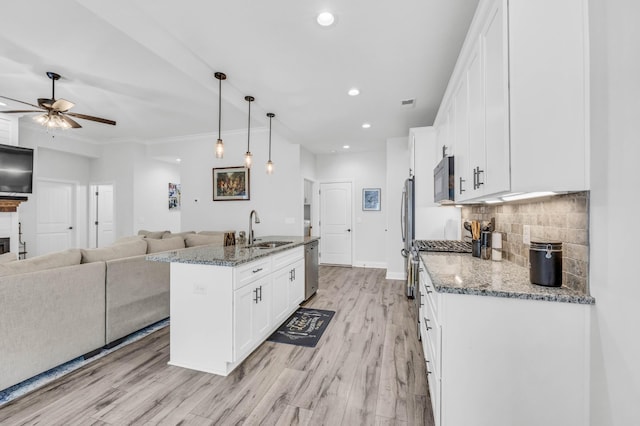 1055 Wittys Way, Clarksville, TN 37043 - kitchen featuring a ceiling fan, stainless steel appliances, light wood-style flooring, white cabinets, and open floor plan