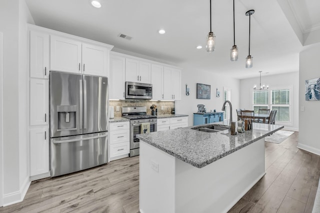 1055 Wittys Way, Clarksville, TN 37043 - kitchen featuring stainless steel appliances, white cabinetry, light wood-style flooring, tasteful backsplash, and recessed lighting