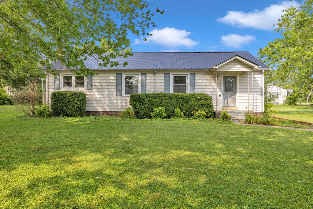 111 Truman St, Waverly, TN 37185 - view of front of house with a metal roof and a front yard