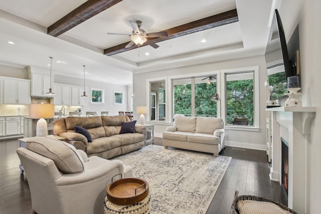 2016 Oliver Dr, Mount Juliet, TN 37122 - living room featuring a ceiling fan, dark wood-style flooring, beamed ceiling, recessed lighting, and a warm lit fireplace