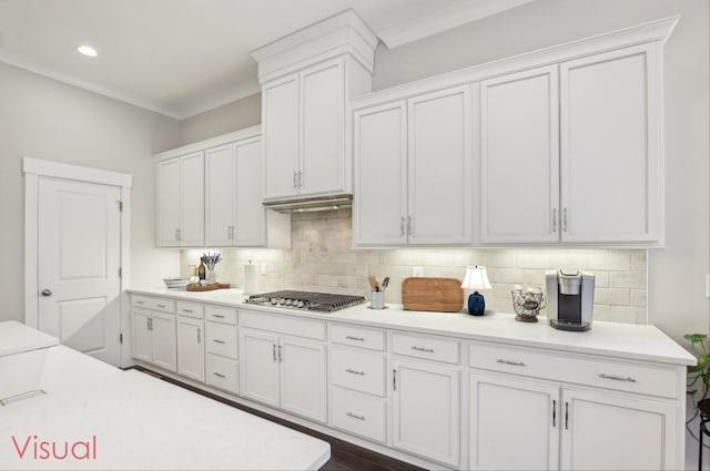 2016 Oliver Dr, Mount Juliet, TN 37122 - kitchen featuring white cabinets, stainless steel gas cooktop, tasteful backsplash, light countertops, and crown molding