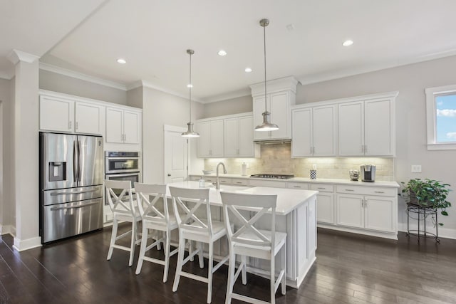 2016 Oliver Dr, Mount Juliet, TN 37122 - kitchen with stainless steel appliances, ornamental molding, dark wood finished floors, decorative backsplash, and white cabinets