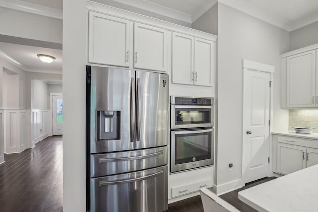 2016 Oliver Dr, Mount Juliet, TN 37122 - kitchen with appliances with stainless steel finishes, dark wood finished floors, ornamental molding, decorative backsplash, and white cabinets