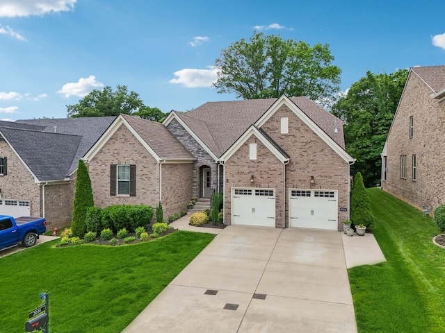 2016 Oliver Dr, Mount Juliet, TN 37122 - view of front of house featuring brick siding, concrete driveway, a front lawn, and an attached garage