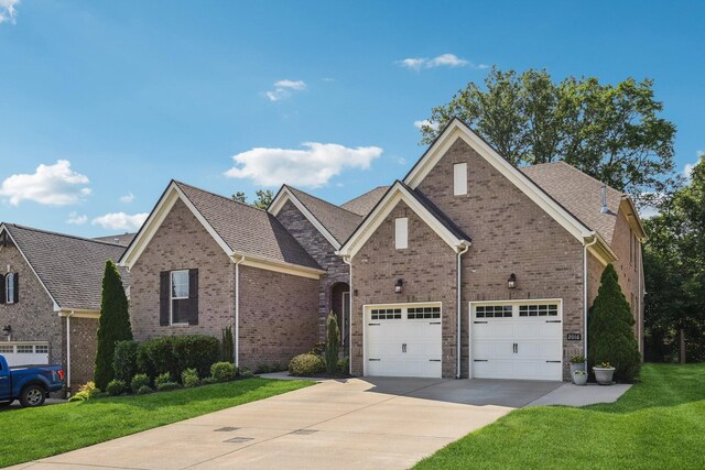 2016 Oliver Dr, Mount Juliet, TN 37122 - traditional-style home featuring driveway, brick siding, a front yard, and a shingled roof