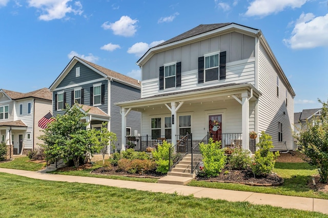 652 Taylor Bend Rd, Columbia, TN 38401 - view of front of house with board and batten siding, covered porch, and a front yard
