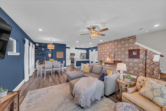 652 Taylor Bend Rd, Columbia, TN 38401 - living room with ceiling fan, an accent wall, wood finished floors, and recessed lighting
