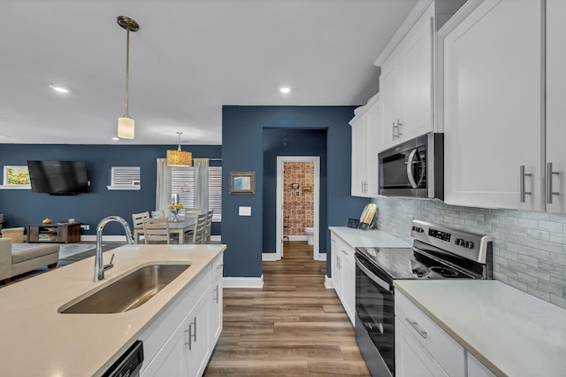 652 Taylor Bend Rd, Columbia, TN 38401 - kitchen with appliances with stainless steel finishes, light countertops, backsplash, decorative light fixtures, and healthy amount of natural light