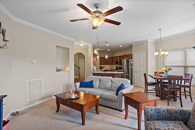 341 Lola Ln, Cottontown, TN 37048 - living room with arched walkways, ceiling fan, ornamental molding, a chandelier, and light carpet