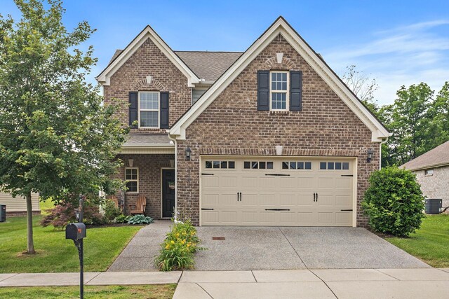 341 Lola Ln, Cottontown, TN 37048 - traditional-style home with driveway, brick siding, a front lawn, and roof with shingles