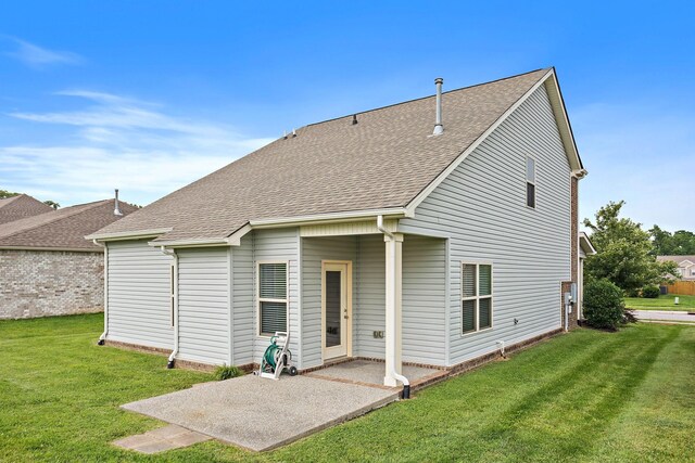 341 Lola Ln, Cottontown, TN 37048 - rear view of property featuring a shingled roof, a lawn, and a patio