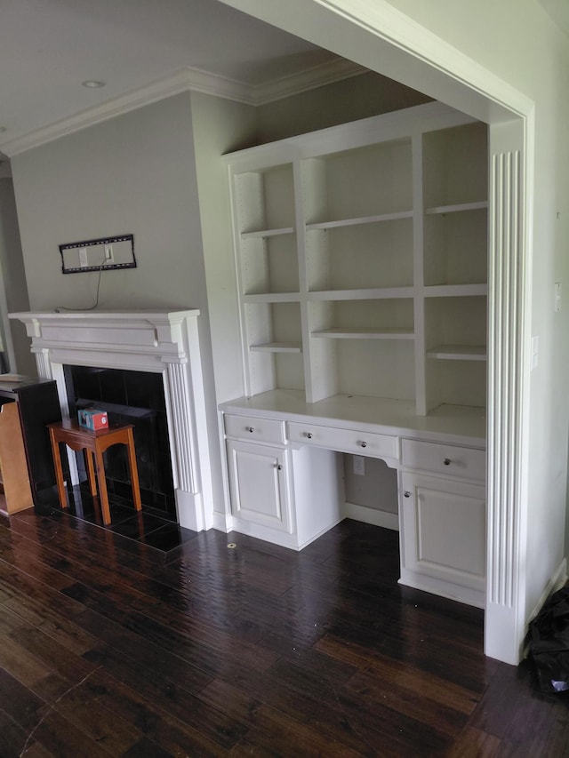 179 Avalon Dr, Gallatin, TN 37066 - unfurnished living room featuring a fireplace, crown molding, dark wood-type flooring, and built in study area